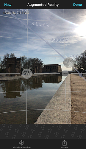 Augmented reality view showing the Moon's path overlaid on a real photo of a monument
